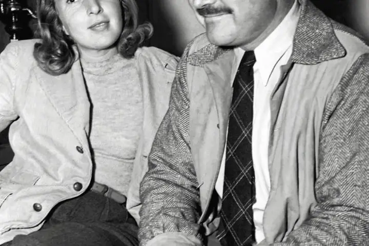 Ernest Hemingway i jego żona Mary Welsh siedzą blisko siebie, ona uśmiecha się lekko.